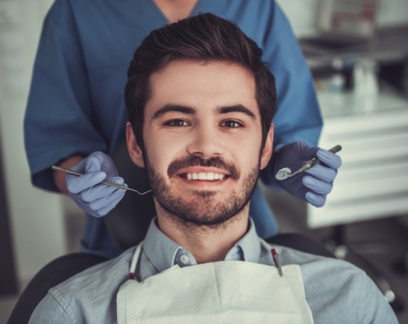 Smiling young man sitting in dental chair