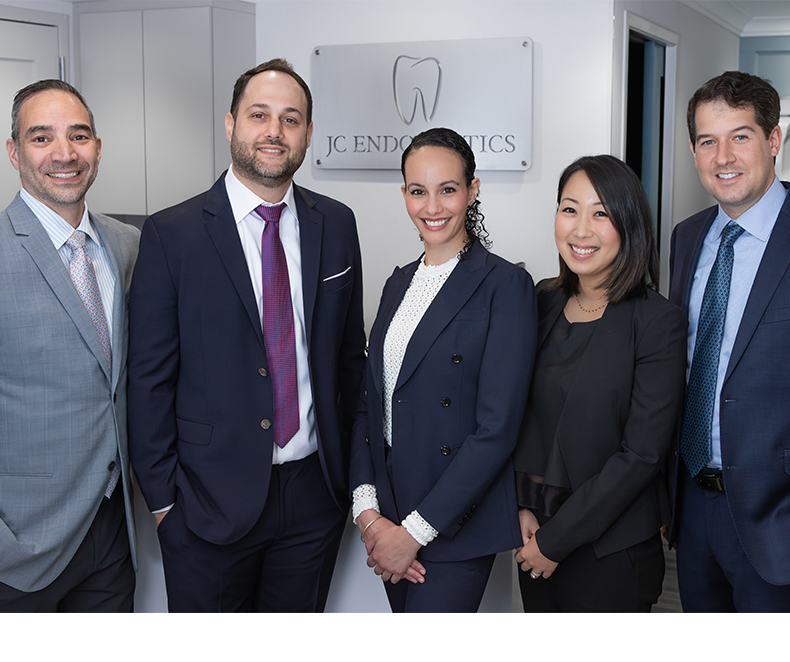 Five smiling emergency dentists in New York City at J C Endodontics Root Canal Specialists