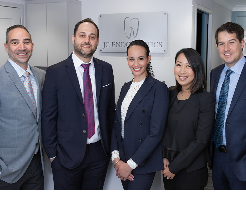 Five smiling New York City endodontists at J C Endodontics Root Canal Specialists in New York City